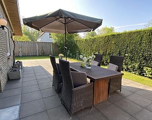 Cozy dining area on terrace of VZ339 Holiday home Kamperland, surrounded by greenery in North Beveland.