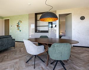 Cozy dining room in Veerweg 163 vacation home, Kamperland, North Beveland, Zeeland with modern lighting.