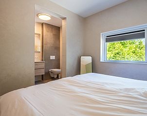 Modern bathroom adjacent to bedroom in Veerweg 163 vacation home, Kamperland, Noord-Beveland, Zeeland.