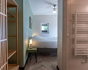 Walk-in closet and bathroom in second bedroom of Veerweg 163 vacation home, Kamperland, Noord-Beveland, Zeeland.