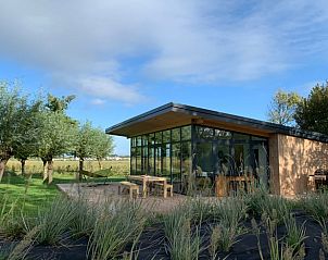 Modern vacation home in Kamperland with spacious veranda surrounded by nature, perfect for relaxation in North Beveland, Zeeland.