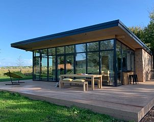 Stylish vacation home in Kamperland with glass facades and spacious outdoor space in North Beveland, Zeeland.