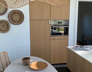 Modern kitchen of vacation home in Kamperland with wooden finish and stylish decoration in North Beveland, Zeeland.
