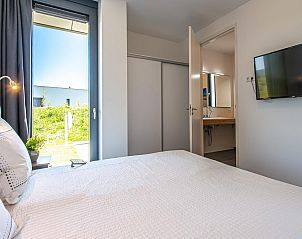 Moderne buitenkant van Duinvallei 22, vakantiehuis in Kamperland, Noord-Beveland, met strakke lijnen en veel glas.