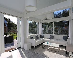 Bright and spacious living room of Villa Jula, Holiday home Zonnedorp 4 in Renesse, overlooking the garden.