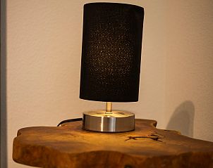 Stijlvolle tafellamp op houten bijzettafel in Vakantiehuis Zonnedorp 1, Solskin in Renesse.