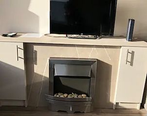 TV and fireplace in VZ1012 Holiday chalet in Renesse, for cozy evenings in Schouwen-Duiveland, Zeeland.