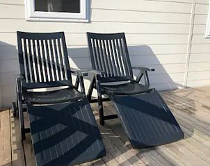 Sun beds on the terrace of VZ1012 Holiday Chalet in Renesse, perfect for relaxing in Schouwen-Duiveland, Zeeland.