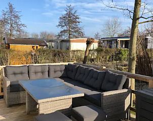 Outdoor lounge with comfortable seating at VZ1012 Holiday Chalet in Renesse, Schouwen-Duiveland, Zeeland.