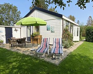 Terrace of VZ891 Holiday home in Renesse with parasol and seating area, Schouwen-Duiveland, Zeeland.