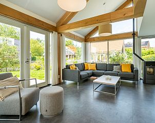 Cozy sitting area in Holiday Home Zonnedorp 22 Anoes, Renesse, overlooking the garden.