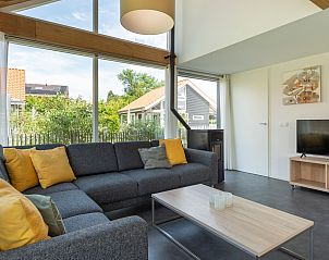Comfortable sofa and TV in Holiday home Zonnedorp 22 Anoes in Renesse, Zeeland.