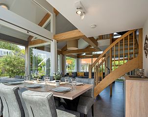 Modern dining room in Holiday home Zonnedorp 22 Anoes in Renesse with wooden staircase.