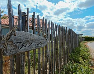 Wooden fence with sign at Holiday Home Zonnedorp 18, Duinhuis 18 in Renesse, Schouwen-Duiveland, Zeeland.