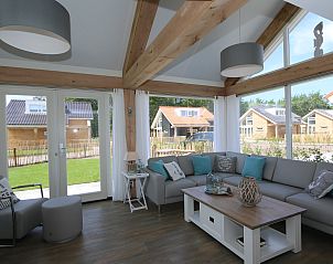 Comfortable sitting area in Holiday home Zonnedorp 18, Duinhuis 18 in Renesse, Zeeland with garden view.