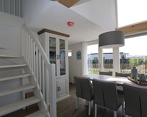 Dining area in Holiday Home Zonnedorp 18, Duinhuis 18 in Renesse, Zeeland with stylish dining table and chairs.