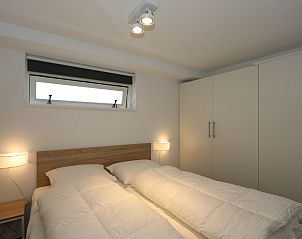 Bedroom in Holiday Home Zonnedorp 18, Duinhuis 18 in Renesse, Zeeland with comfortable bed and closet space.