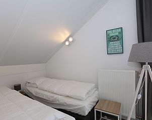 Bedroom with sitting area in Holiday home Zonnedorp 18, Duinhuis 18 in Renesse, Zeeland.