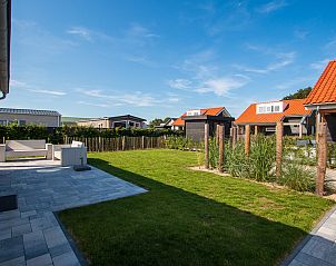Sunny terrace at Holiday home Zonnedorp 28 in Renesse, surrounded by nature.