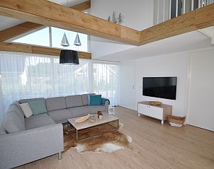 Bright living room in Holiday home Zonnedorp 28 with comfortable seating area in Renesse.