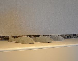 Decorative fish statues in Holiday home Zonnedorp 28 in Renesse, Zeeland.