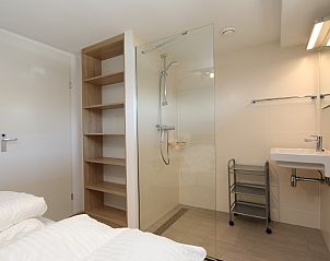 Stylish bathroom with walk-in shower in The White Beach House in Renesse, Zeeland.