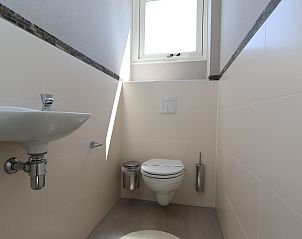 Stylish toilet with natural light in The White Beach House in Renesse, Zeeland.
