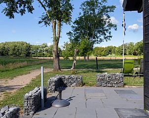 Spacious terrace at Huisje in Renesse, a vacation home in Schouwen-Duiveland, ideal for relaxation.