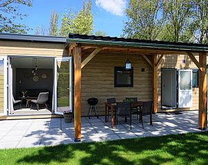 Veranda met zitgelegenheid bij Huisje in Noordwelle, vakantieaccommodatie in Zeeland.