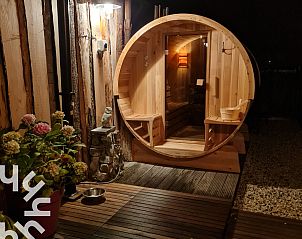 Houten sauna en bloementuin bij vakantiehuis ZE1221 in Sint-Annaland, Tholen voor ontspanning.