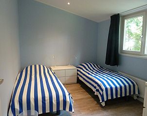 Double bedroom with blue accents in VZ1136 Detached vacation home in Koudekerke, Walcheren, Zeeland.