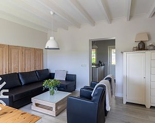 Modern living room with stairs in vacation home ZE068 in Oostkapelle, Walcheren, Zeeland.