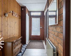 Dining room with wooden furniture in vacation home ZE366 in Oostkapelle, Walcheren.