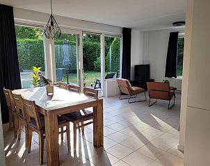 Dining area overlooking garden in VZ2330 Holiday home Oostkapelle, Walcheren, Zeeland.
