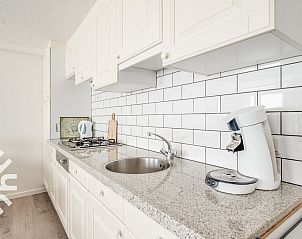 White tiled bathroom with toilet in vacation home ZE118, Oostkapelle, Walcheren, Zeeland.