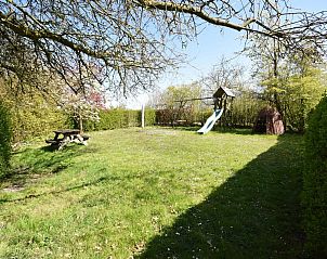 Ruime tuin met speeltoestellen bij VZ2316 Vrijstaand vakantiehuis in Oostkapelle, Walcheren, Zeeland.