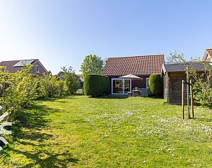 Cozy corner with table and chair in vacation home ZE414, Oostkapelle, Walcheren, Zeeland.