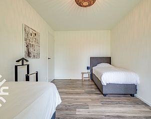 Enjoy the garden at vacation home ZE145 in Oostkapelle, Walcheren, with comfortable seating.