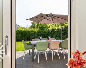 Overview of vacation home ZE145 in Oostkapelle, Walcheren, with sunny garden and sitting areas.