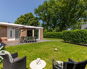 Green surroundings of vacation home ZE145 in Oostkapelle, Walcheren, with deck chairs in the garden.