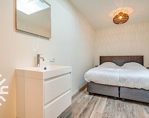 Bedroom with garden view in vacation home ZE145 in Oostkapelle, Walcheren, Zeeland.