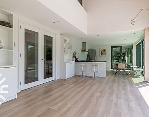 Living room of vacation home ZE263 in Westkapelle with large windows and comfortable sofa.