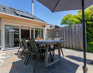 Terras van vakantiehuis ZE1422 in Zoutelande, Walcheren, met ruime eettafel en parasol.