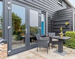 Private terrace of vacation home ZE583 in Vrouwenpolder, Walcheren, ideal for outdoor dining in the fresh air of Zeeland.