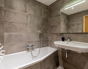 Stylish bathroom of vacation home ZE583 in Vrouwenpolder, Walcheren with a bathtub in Zeeland.