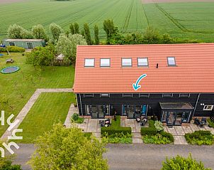 Spacious bedroom in vacation home ZE583 in Vrouwenpolder, Walcheren, with comfortable chairs in Zeeland.