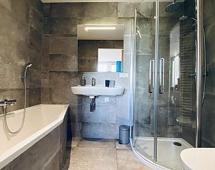 Stylish bathroom with shower and bathtub in VZ583 Studio Vrouwenpolder.