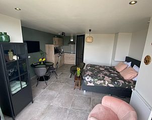 Open living space in Holiday home in Vrouwenpolder, Walcheren, Zeeland with kitchen and sitting area.