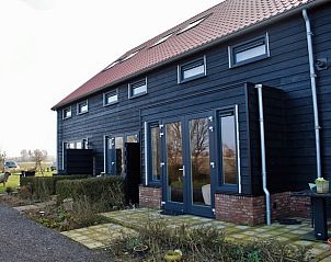 Terrace at Holiday Home in Vrouwenpolder, Walcheren, Zeeland with seating and views.