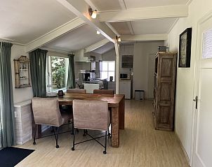 Dining area in vacation home ZE120, Veere, Walcheren, with rustic table.
